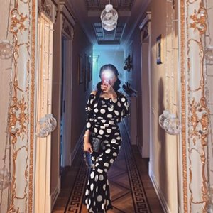 A women taking a photo in a mirror